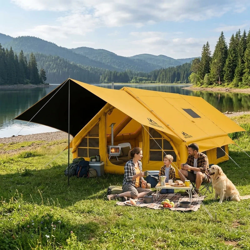 Yellow inflatable cabin tent with black awning and wood stove, family with their dog camping by a mountain lake