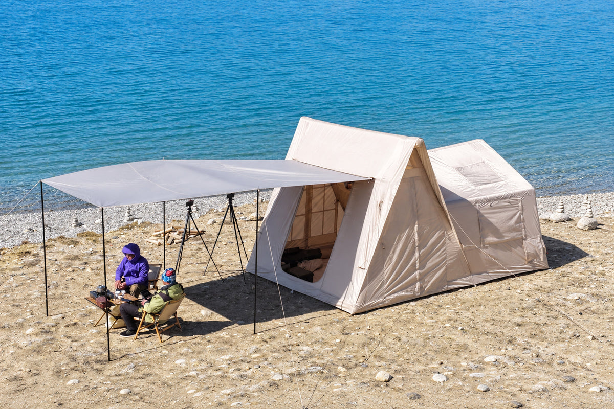 Khaki A-Frame tent pitched at a campsite with its side awning raised.