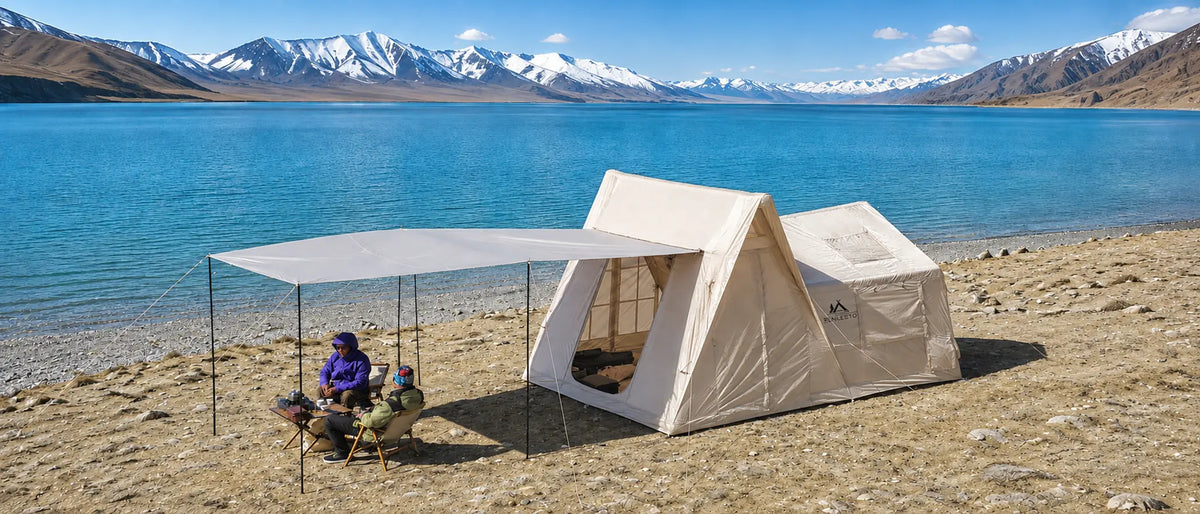 Senleeto inflatable tent with an extended awning beside a turquoise alpine lake and snow-covered mountains.
