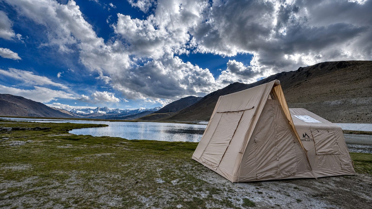 Senleeto Grand Air Cabin inflatable glamping tent pitched beside a mountain lake on the Tibetan Plateau