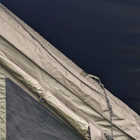 Zipper seam joining the army green canopy to the tent.