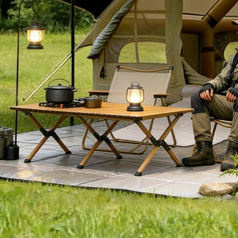 Table and chairs outside the khaki Cabin tent