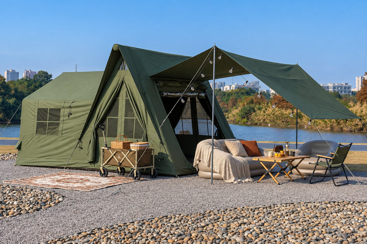 Green A-Frame tent pitched at a campsite with its side awning raised.