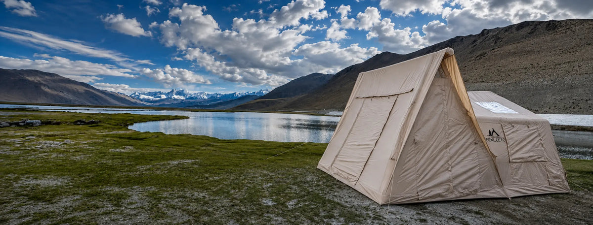 Senleeto inflatable air-beam cabin tent beside a plateau lake with snow-capped mountains.