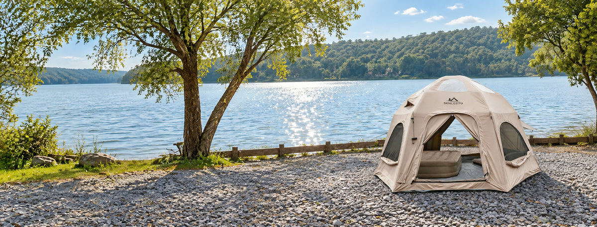 Khaki Dome tent with an open entrance beside a lake.