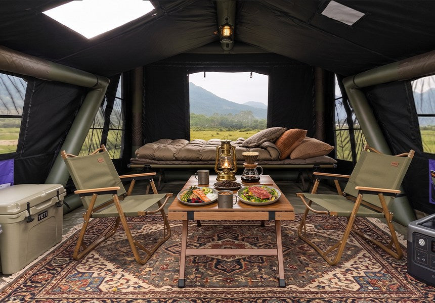 Blackout interior of a purple Senleeto A-Frame tent arranged with cots, chairs, and a table