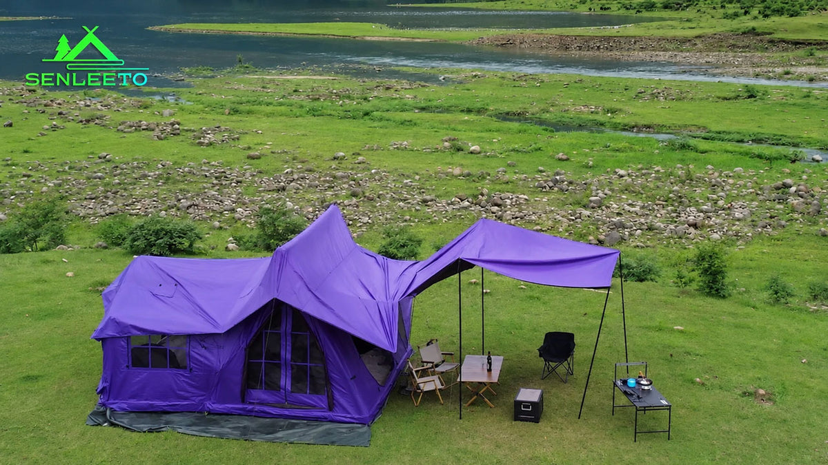 Senleeto purple inflatable cabin tent with rainfly and extended canopy at a lakeside campsite.